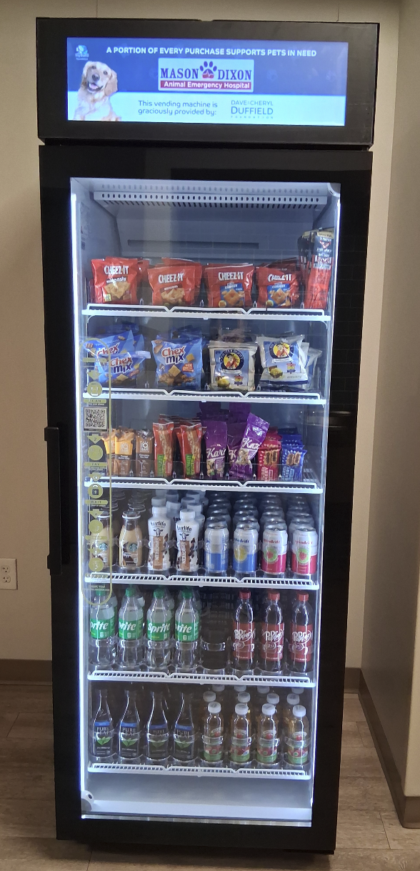 Branded food and beverage vending machine with digital display showing hospital branding