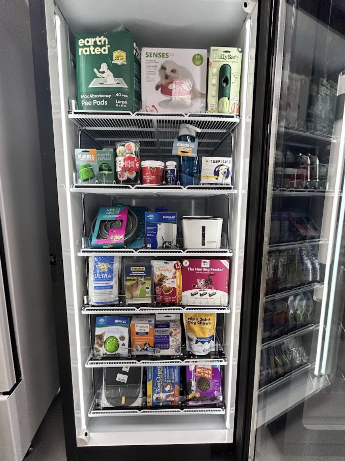 Pet products vending machine stocked with treats, toys, and pet care essentials